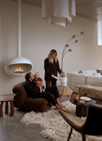 Paul white hanging bioethanol fireplace lit in a high-ceilinged lounge, ARDĒO